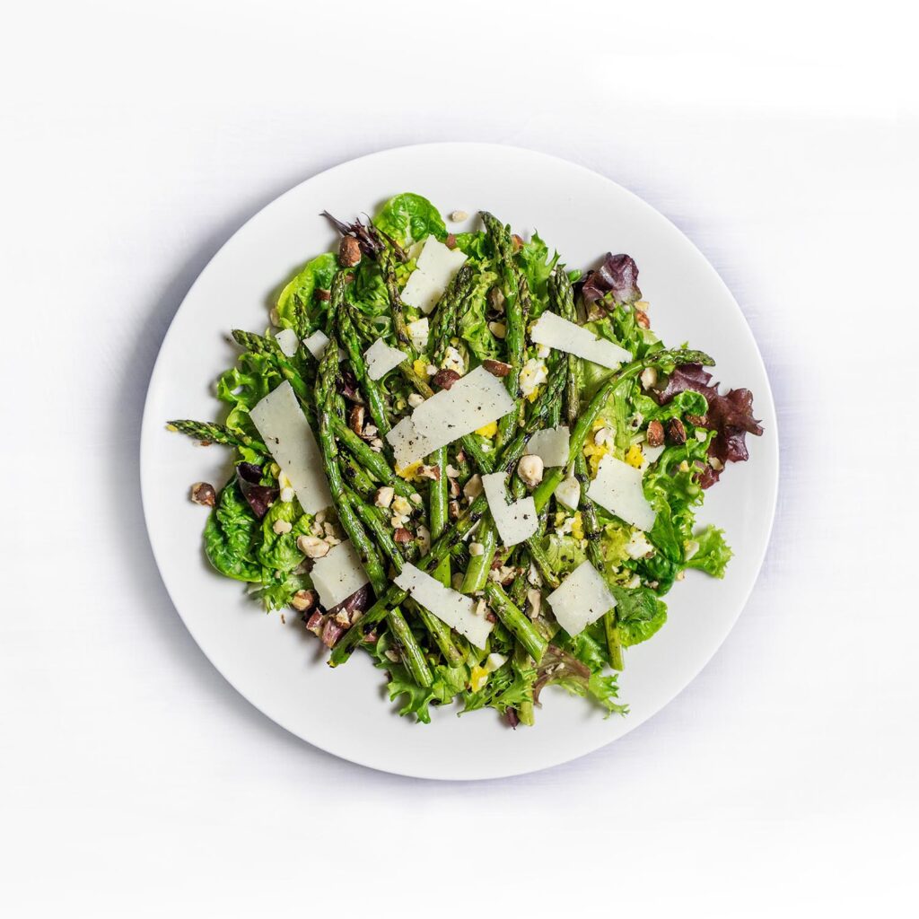 Plate of asparagus topped with cheese