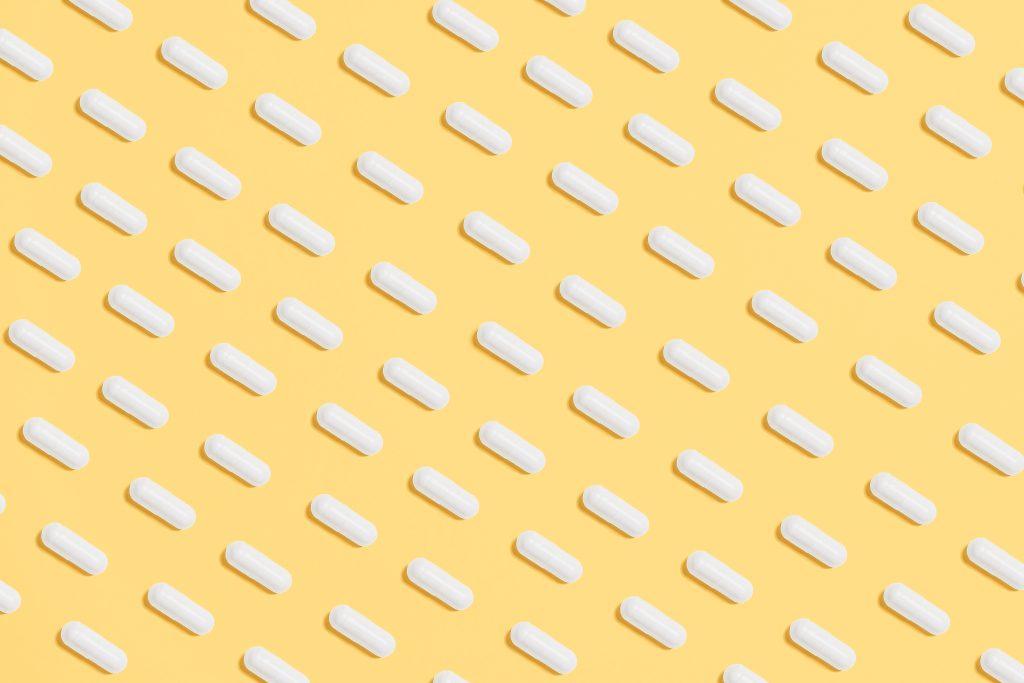 white pills on a yellow background